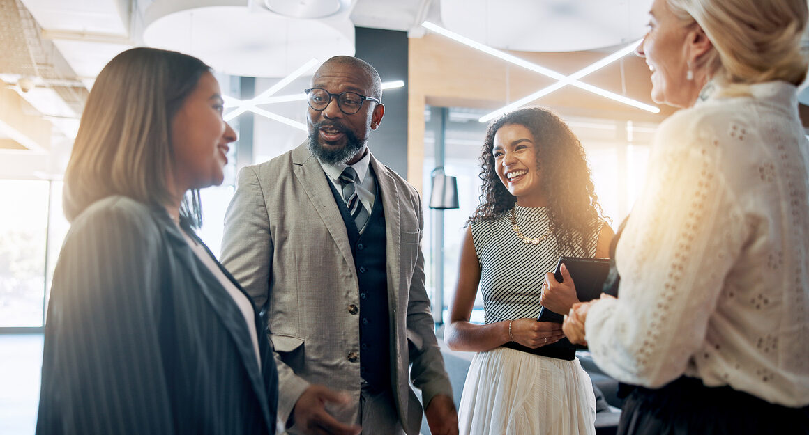 Discussion, smile and business people in lobby for teamwork, schedule update or conference hall advice. Staff, project and keynote speaker in meeting for networking, seminar or career event review