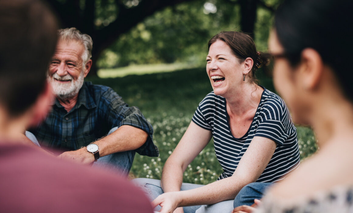 Cheerful woman in the park with her friends